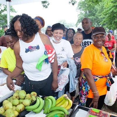 Group of people in line to select fresh fruits and vegetables