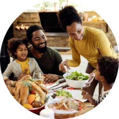 Mother serving her family salad at dinner