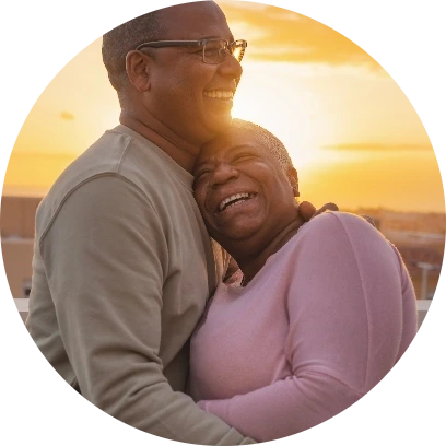 Older couple embracing each other at sunset